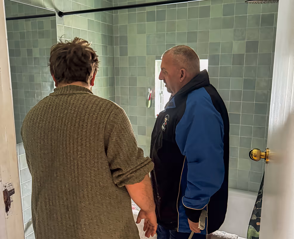 Mick for quick mick's plumbing in talks with client about new shower head installs at their house in katoomba